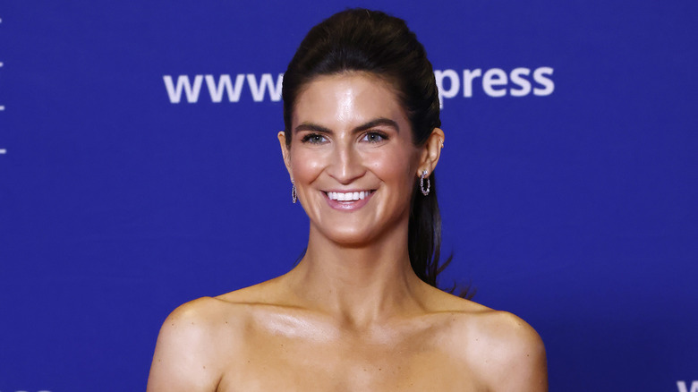 Kaitlan Collins smiling for the press at the WHCD