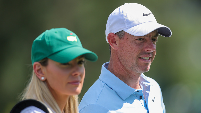 Erica Stoll on the golf course with Rory McIlroy