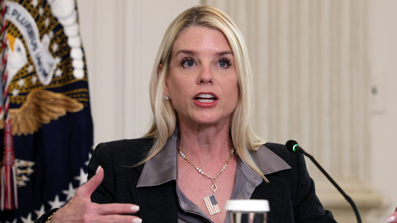 Pam Bonding speaking while wearing a necklace with an American flag pendant.