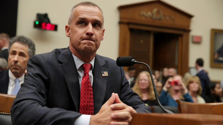 Corey Lewandowski seated behind a microphone and staring off in the distance.