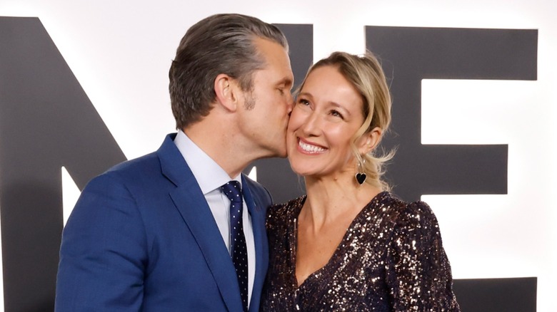 Pete Hegseth kissing his wife on the cheek at the premiere for 
