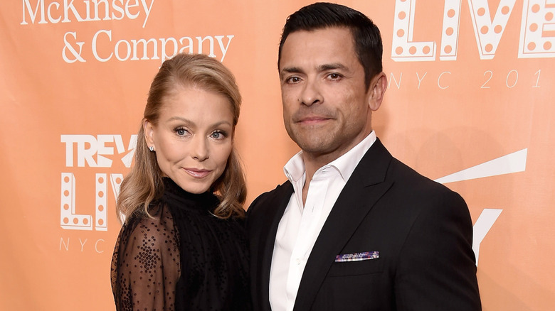 Kelly Ripa and Mark Consuelos wearing black on the red carpet
