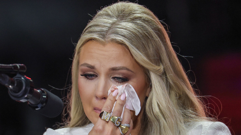 Erika Kirk wiping tears from her face